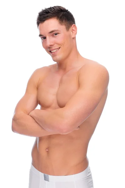 Usmívající se mladý muž s prádlem — Stock fotografie