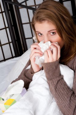 Woman in bed with a handkerchief