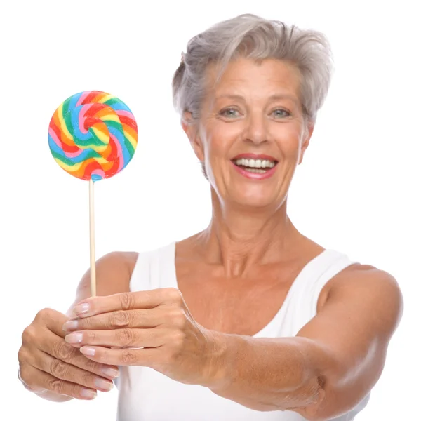 Idősebb nő, édességek — Stock Fotó