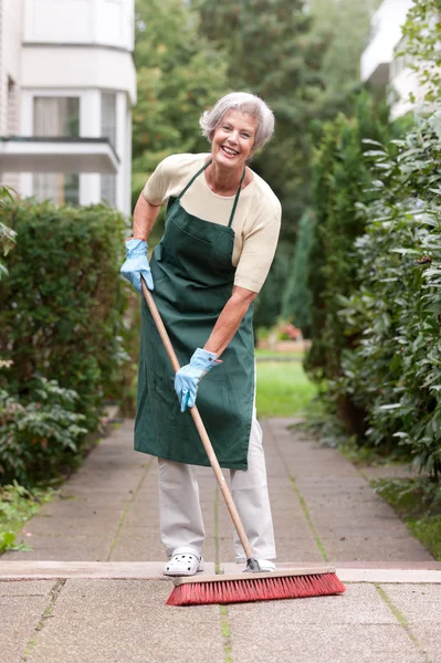 Senior with broom — Stock Photo, Image