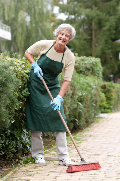 Senior with broom — Stock Photo, Image