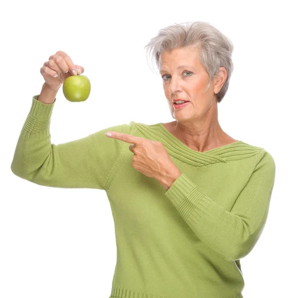 Senior woman with apple Stock Picture