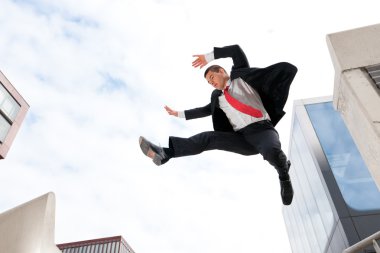 Jumping young business man clipart