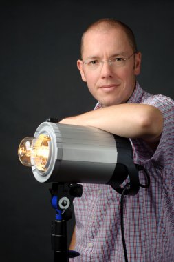 Photographer with studio flash clipart