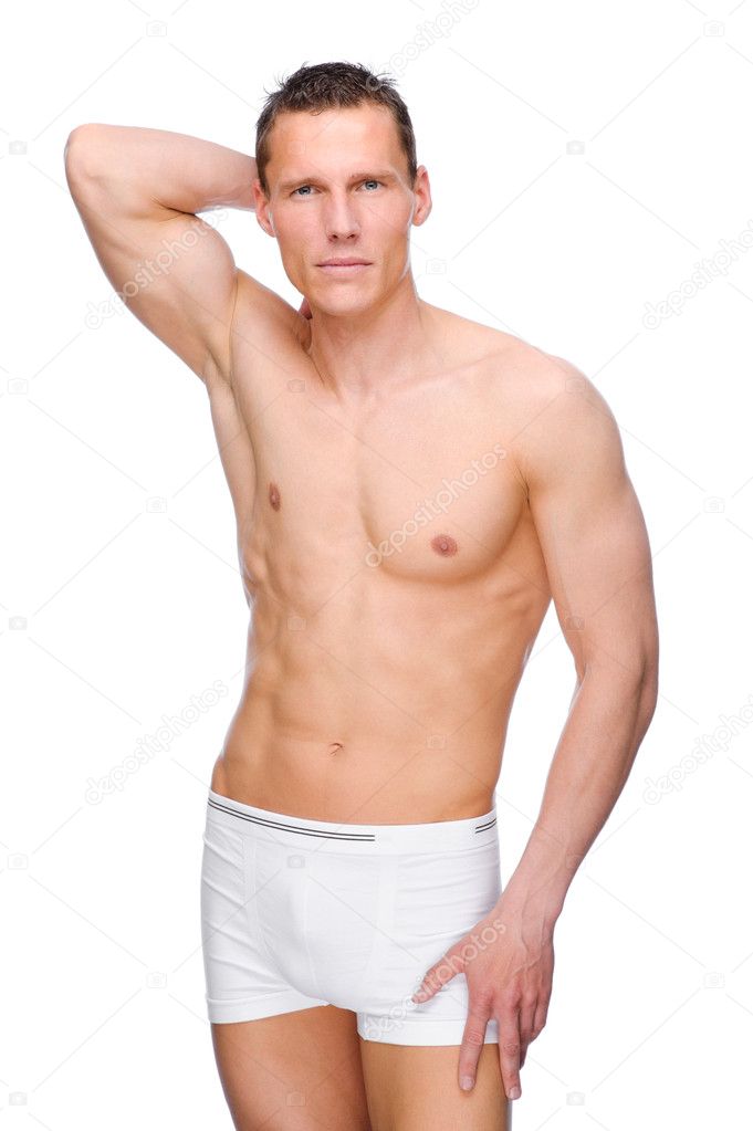 Close-up of Young Man in Boxer Briefs Touching Stomach in Studio