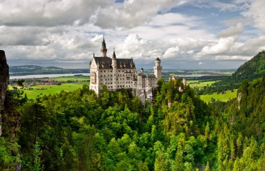 Castle Neuschwanstein in the mountains clipart