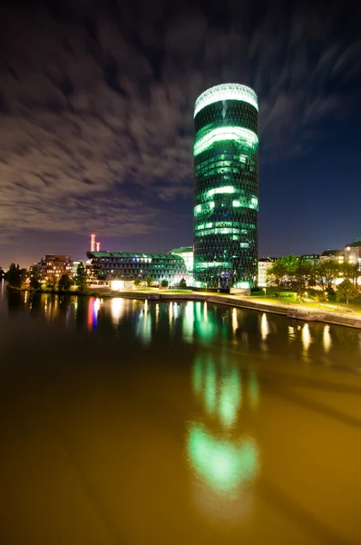 Skyscraper office on the river at night — Stock Photo, Image