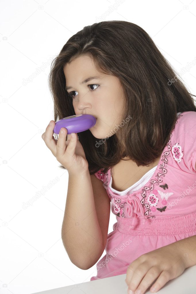 Cute Caucasian girl using an inhaler for Asthma