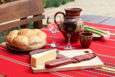Wine, cheese and saussage on table clipart
