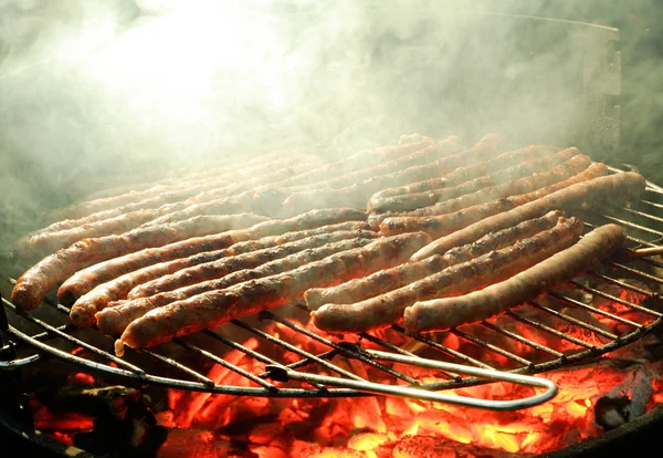 Roasting saussage on a barbecue — Stock Photo, Image
