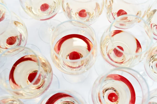 Party glasses with red cherry drink — Stock Photo, Image