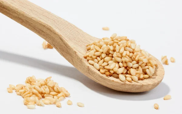 stock image Sesame grains in small wooden spoon