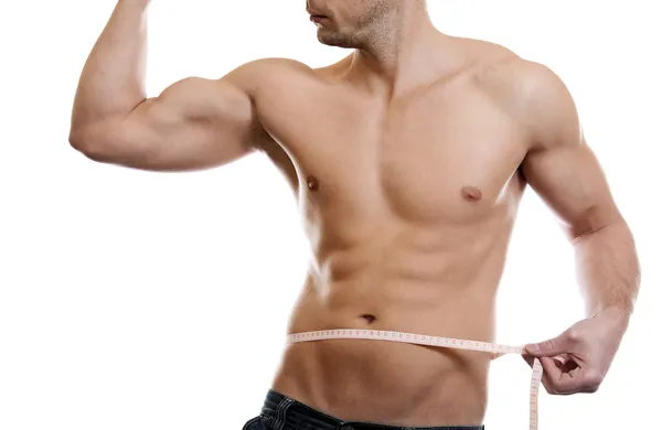 Uomo muscolare che misura la vita — Foto Stock