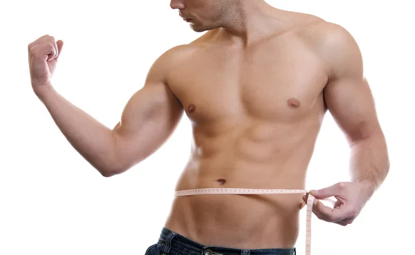 Homem muscular medindo cintura — Fotografia de Stock