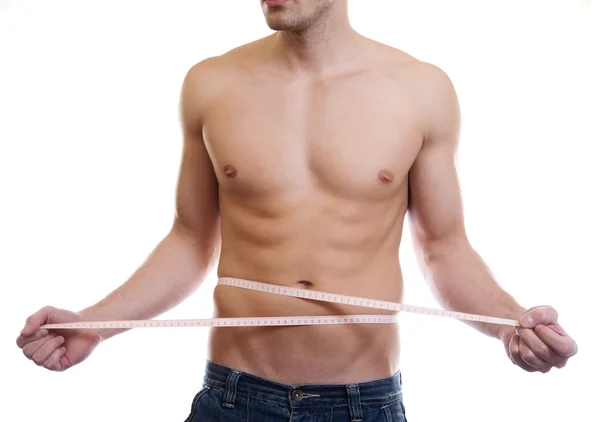 Muscular man measuring waist — Stock Photo, Image