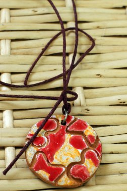 Red and yellow clay amulet clipart