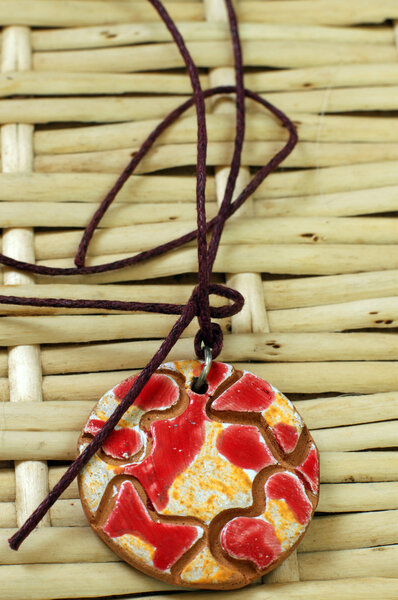 Red and yellow clay amulet