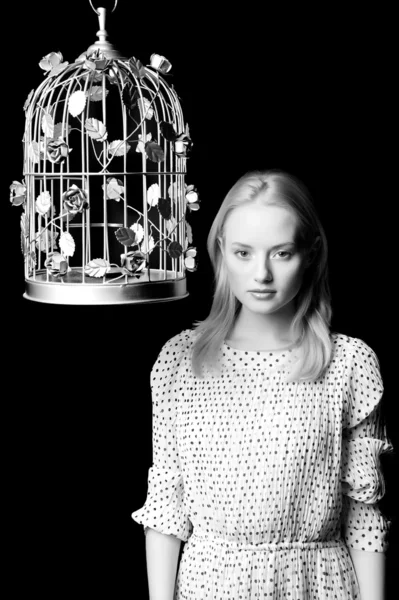 Young blonde girl with cage