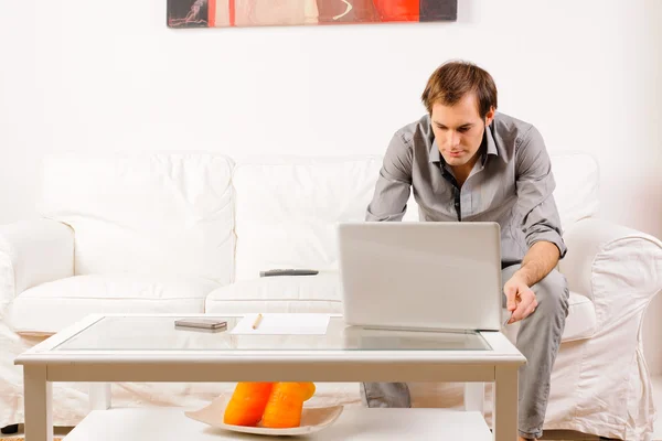 Young man working at home — Stock Photo, Image