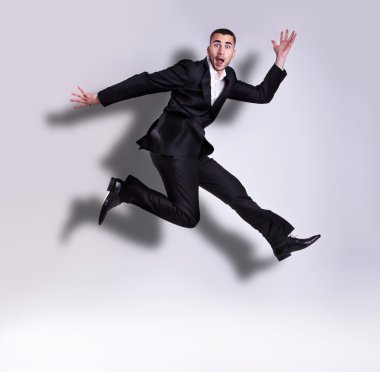 Young handsome businessman jumping clipart