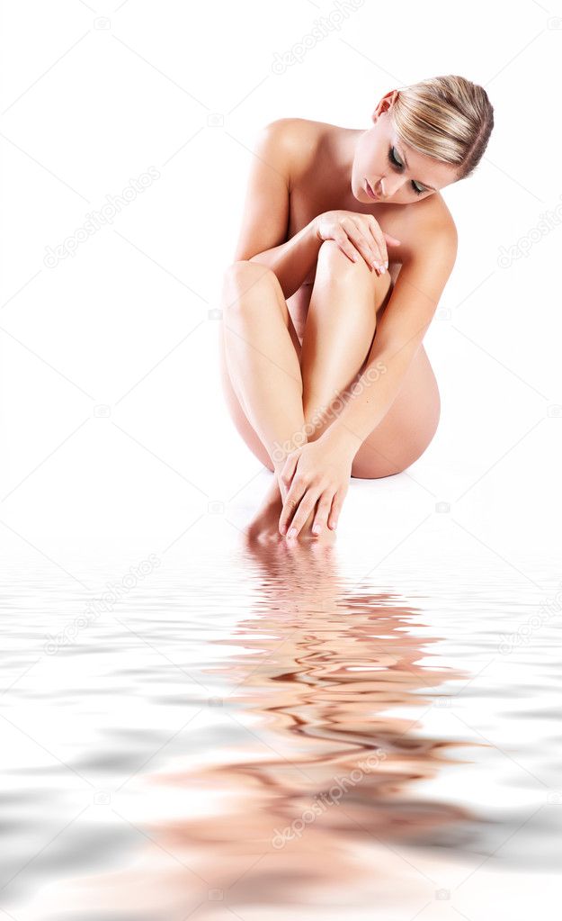 Young woman with reflection on a water surface