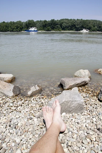 Donau river with boat and feet — Stock Photo, Image