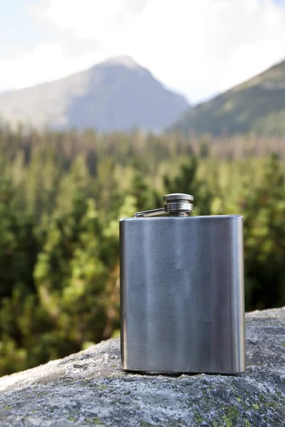 Mountain and silver flask — Stock Photo, Image