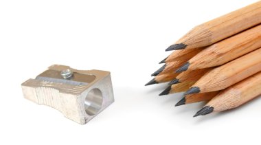 Sharpener and pencils on a white background. clipart