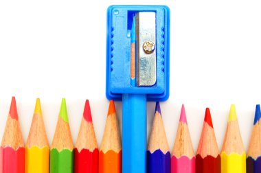 Sharpener and pencils on a white background. clipart