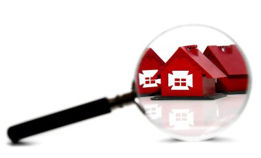 Toy houses and magnifier. On a white background. clipart