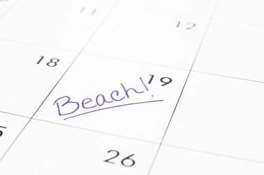 Closeup of a calendar with Beach text clipart