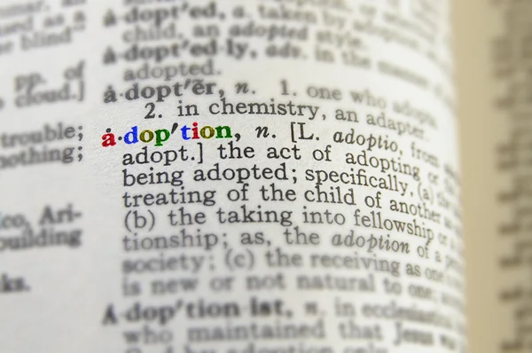 Closeup of adoption definition in colorful letters — Stock Photo, Image