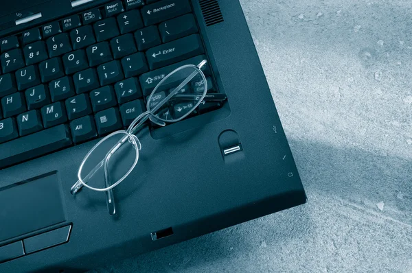 Laptop and glasses — Stock Photo, Image