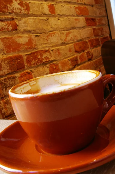 Cappuccino coffee in a mug at a cafe — Stock Photo, Image