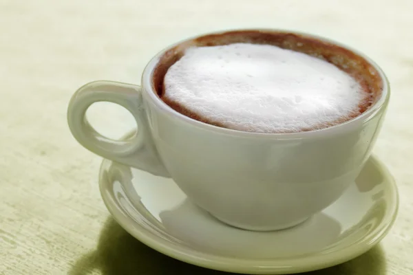 Cappuccino coffee in a mug at a cafe — Stock Photo, Image