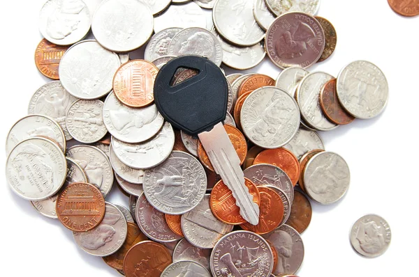 Generic car key on a pile of coins — Stock Photo, Image