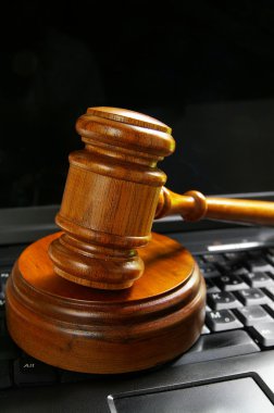 Gavel on top of a laptop clipart