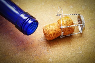 Blue bottle with closeup of a champagne cork clipart