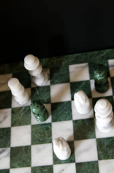 stock image Group of chess pawns on the board, one in the lead