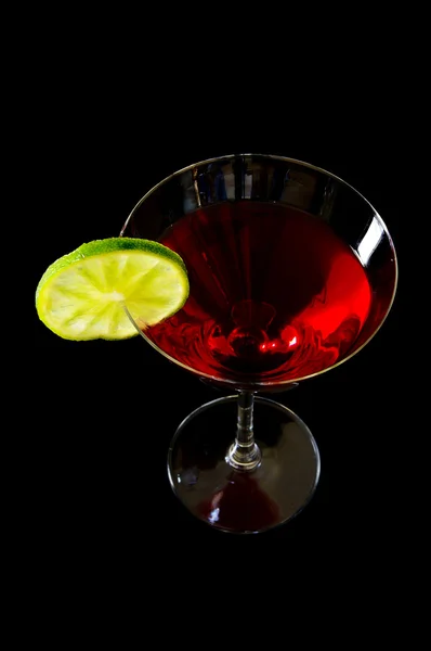 Martini glass with a twist of lime on dark background — Stock Photo, Image