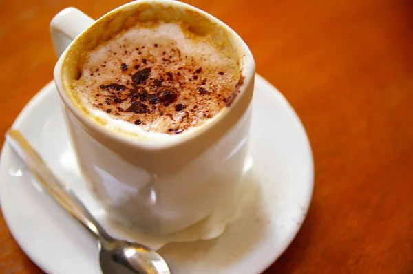 Cappuccino coffee in a mug at a cafe — Stock Photo, Image