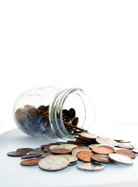 Coin jar with spilled money — Stock Photo, Image