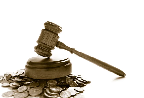 Gavel on a pile of coins — Stock Photo, Image