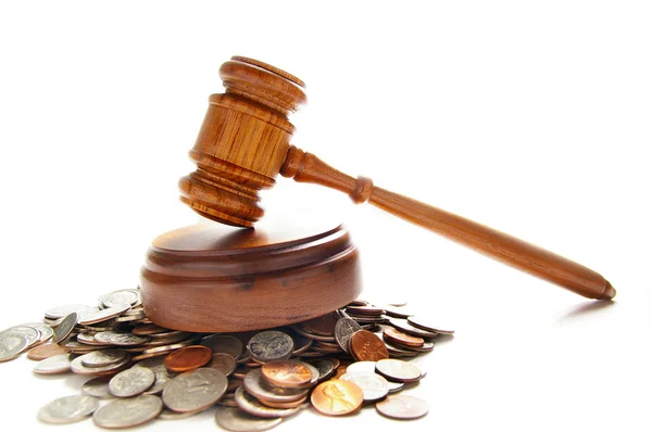 Gavel on a pile of coins — Stock Photo, Image