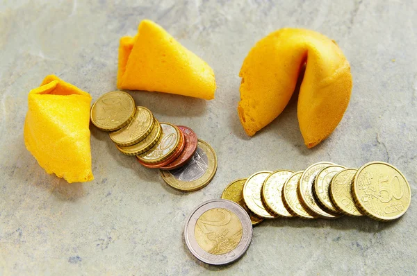 stock image Coins arranged with a fortune cookie