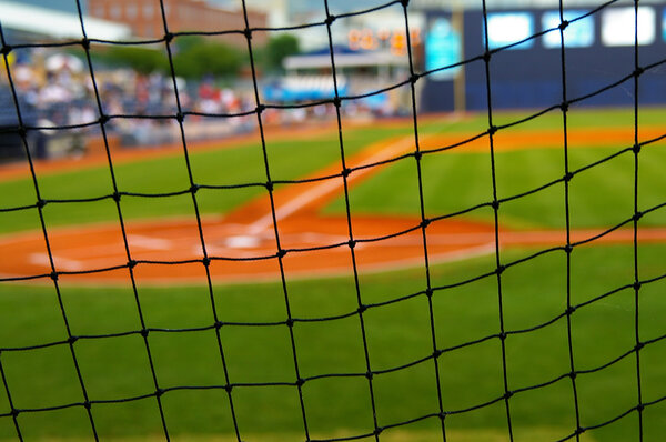 Baseball field, shot from behind the net at home plate
