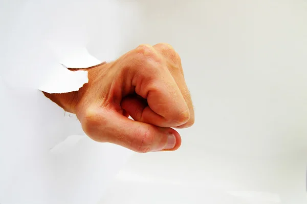 Mão do homem em um punho perfurando através de um buraco — Fotografia de Stock