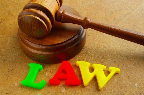 Court gavel and play letters spelling "law" — Stock Photo, Image