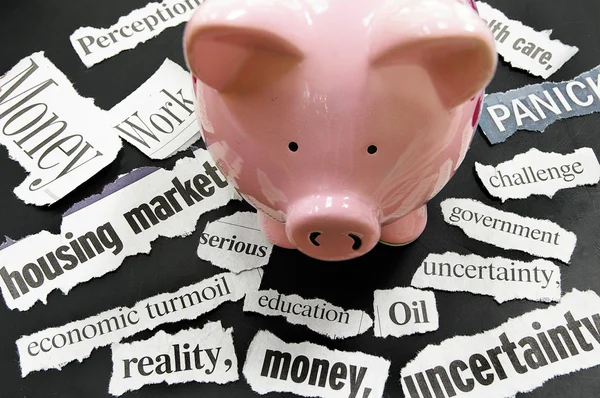 Torn newspaper headlines showing bad news with piggy bank — Stock Photo, Image