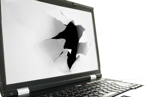 Laptop screen with a torn hole — Stock Photo, Image